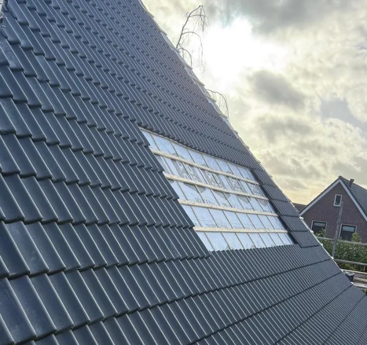 Het afgeronde pannendak, met de laatste rij bij het dakvenster